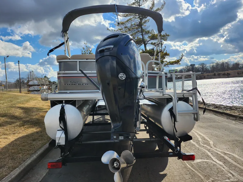 Slide: The Image of 2015 Sun Tracker Party Barge 20 DLX pontoon boat by a scenic lake. - 2