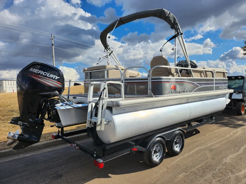 Slide: The Image of 2015 Sun Tracker Party Barge 20 DLX pontoon boat on trailer, with Mercury outboard motor. - 3