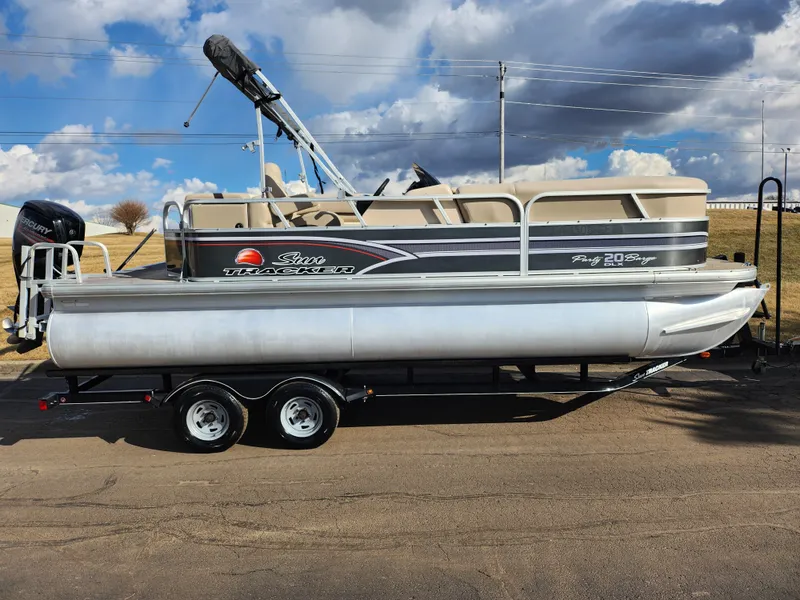 Slide: The Image of 2015 Sun Tracker Party Barge 20 DLX pontoon boat on trailer, under cloudy sky. - 4