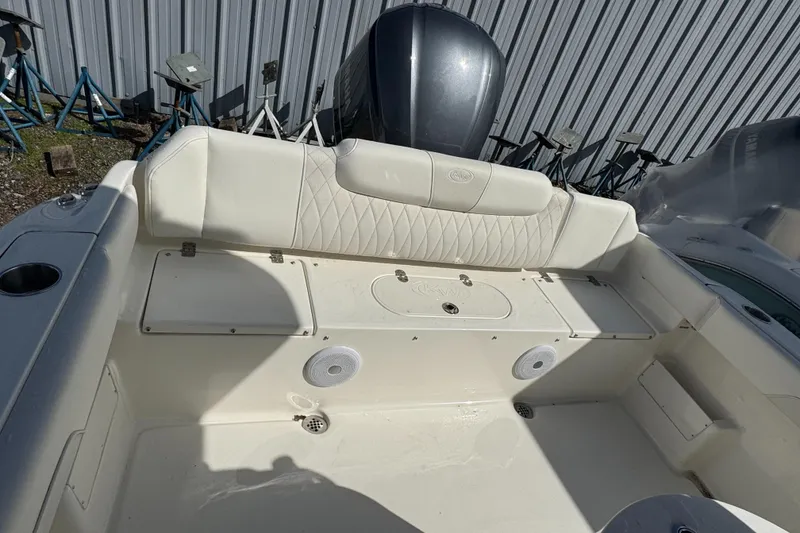 Slide: The Image of 2025 Key West 239FS boat interior with cushioned seating and storage compartments. - 12