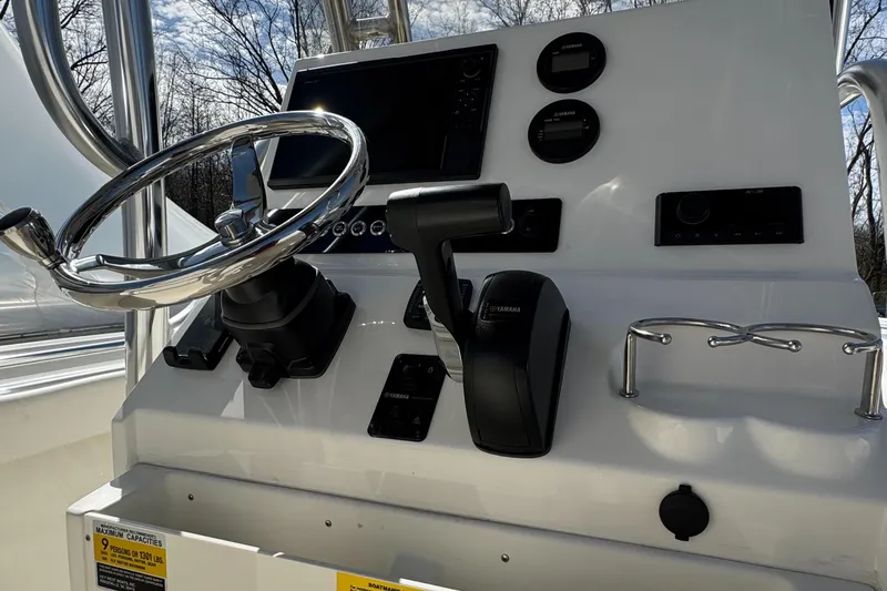 Slide: The Image of 2025 Key West 239FS boat dashboard with steering wheel and controls. - 13