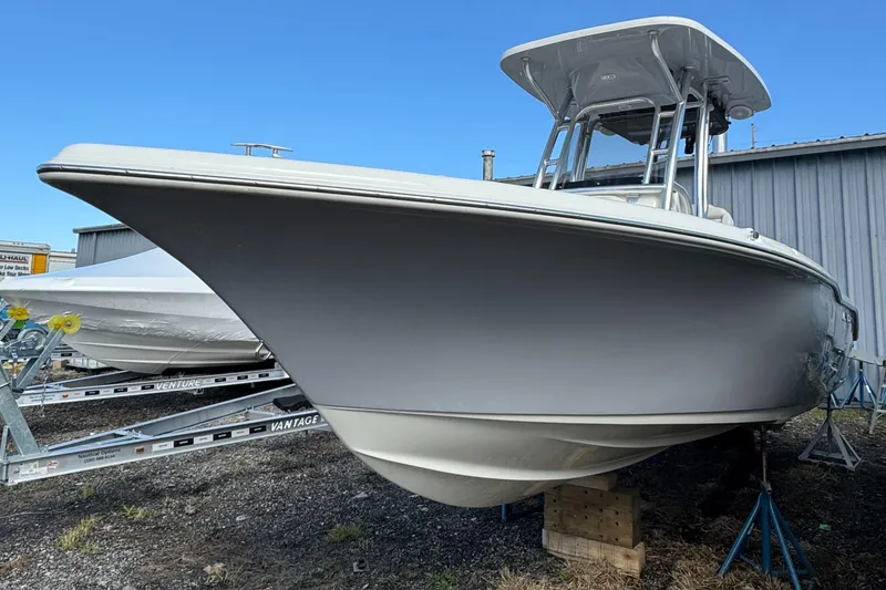 Slide: The Image of 2025 Key West 239FS boat on display, parked on a trailer near a building. - 3