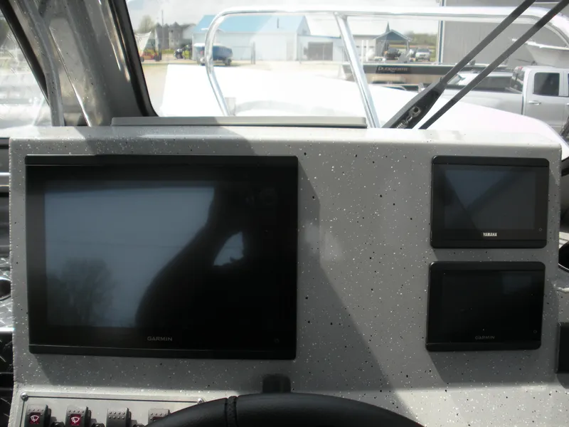 Slide: The Image of Dashboard of 2025 Duckworth 24 Pacific Pro boat with multiple display screens. - 11