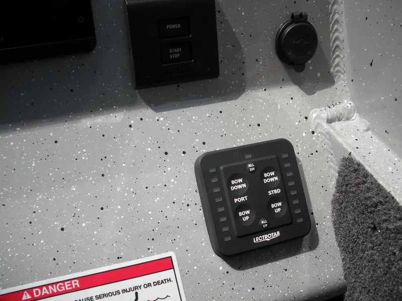 Slide: The Image of Control panel of 2025 Duckworth 24 Pacific Pro boat with Lectrotab trim tab switches. - 12