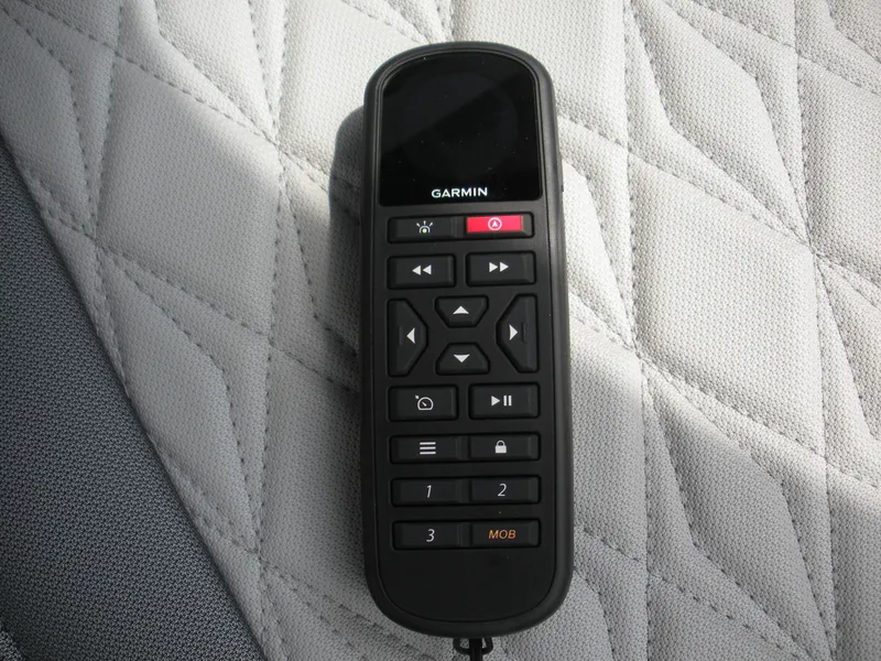Slide: The Image of Garmin remote control on quilted fabric, Duckworth 24 Pacific Pro 2025 model. - 13