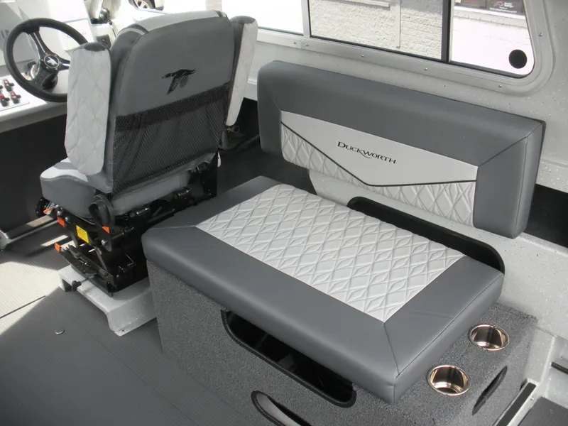 Slide: The Image of Interior of 2025 Duckworth 24 Pacific Pro boat with gray seating and cup holders. - 15