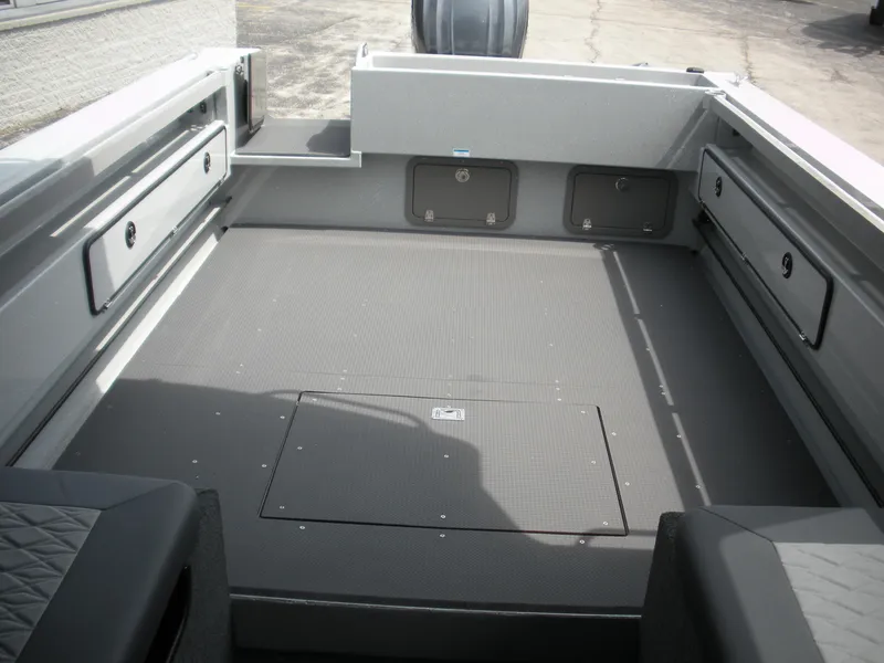 Slide: The Image of Interior view of 2025 Duckworth 24 Pacific Pro boat, featuring spacious deck and storage compartments. - 18