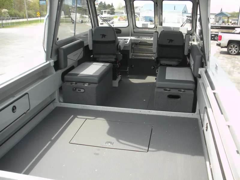Slide: The Image of Interior of 2025 Duckworth 24 Pacific Pro boat, featuring spacious seating and storage. - 19