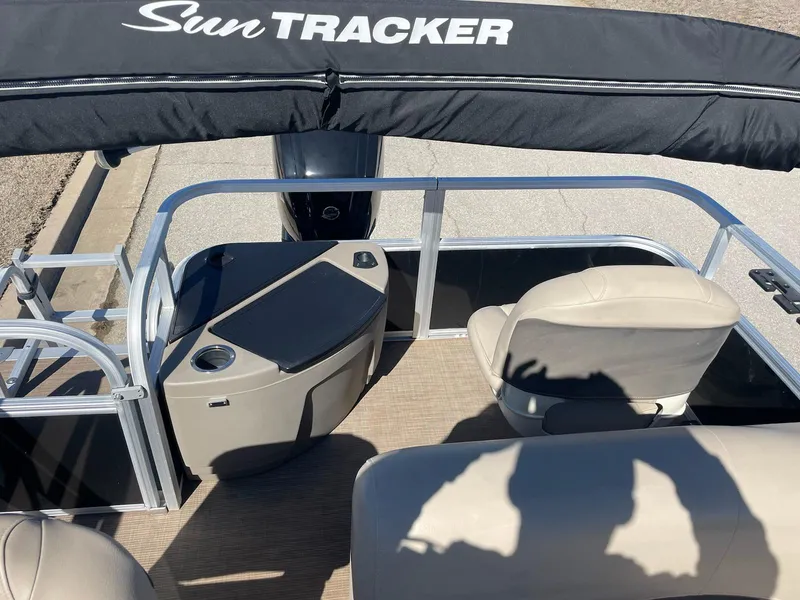 Slide: The Image of 2022 Sun Tracker BB18 boat interior with seating and console under canopy. - 6