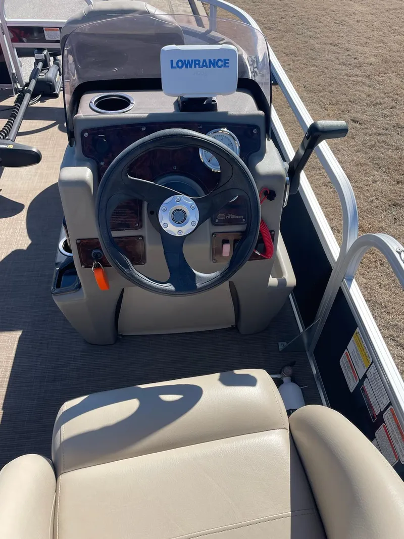 Slide: The Image of 2022 Sun Tracker BB18 boat dashboard with steering wheel and Lowrance navigation system. - 7