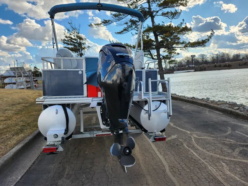 Slide: The Image of 2018 Qwest LS 7518 Cruise FTL pontoon boat by a lake under a cloudy sky. - 2