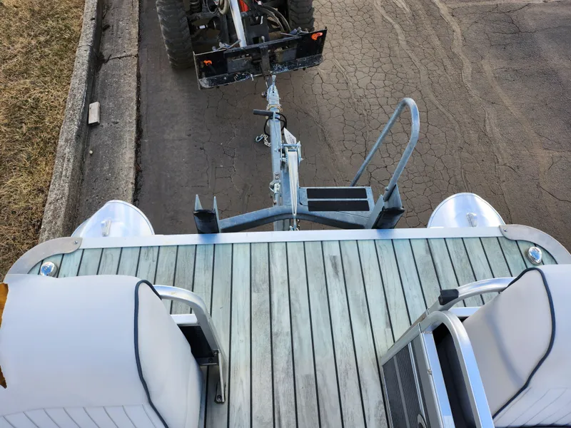 Slide: The Image of 2018 Qwest LS 7518 Cruise FTL pontoon boat hitched to a trailer on a paved road. - 25