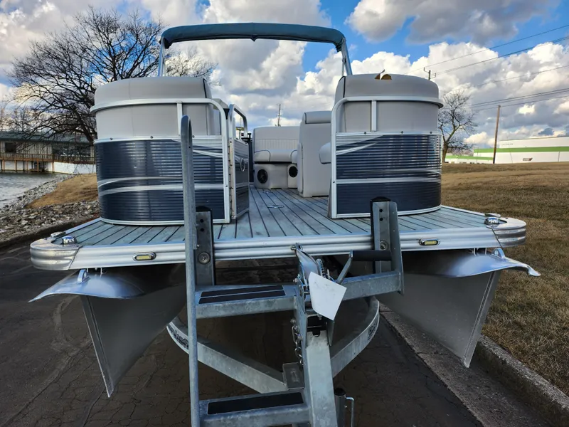 Slide: The Image of 2018 Qwest LS 7518 Cruise FTL pontoon boat on trailer, under cloudy sky. - 6