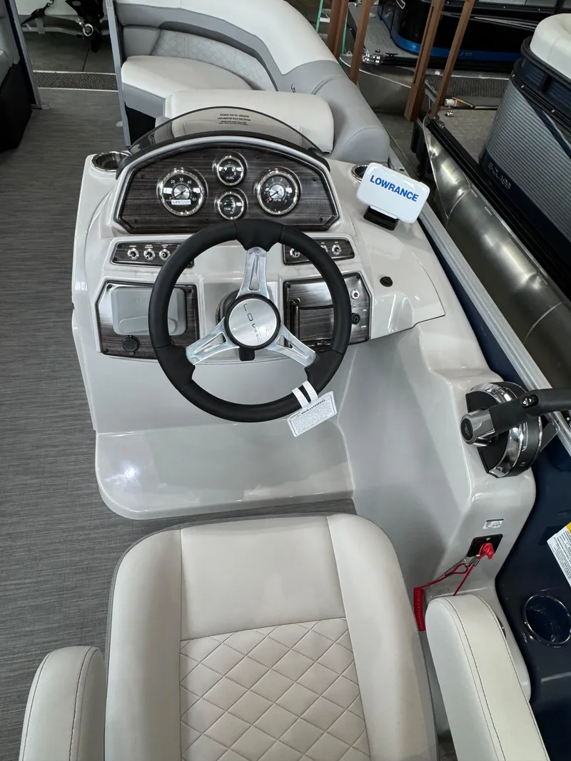 Slide: The Image of 2023 Lowe SS212 Walk-Through boat dashboard with steering wheel and control panel. - 9