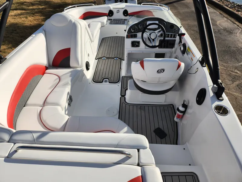 Slide: The Image of 2019 Hurricane SunDeck Sport 202 IO boat interior with white and red seating, steering console. - 10