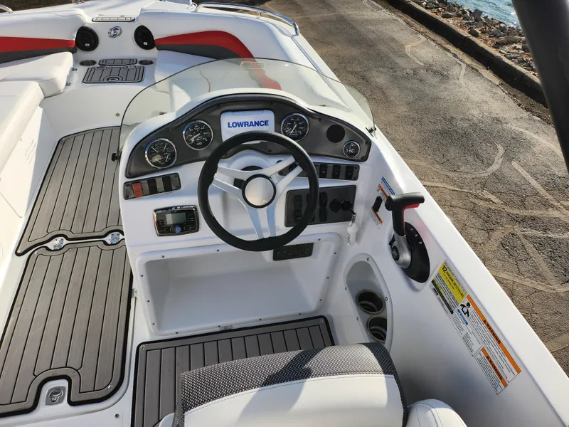 Slide: The Image of 2019 Hurricane SunDeck Sport 202 IO boat dashboard with steering wheel and controls. - 11