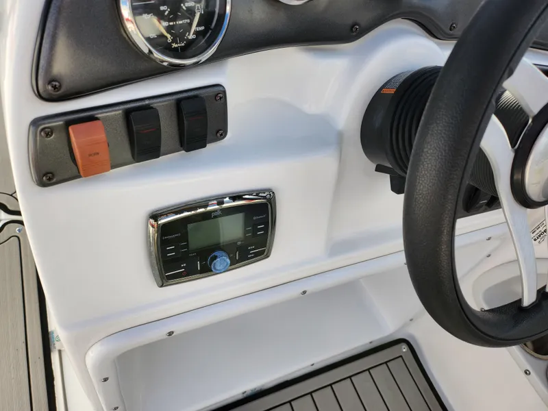 Slide: The Image of 2019 Hurricane SunDeck Sport 202 IO dashboard with controls and steering wheel. - 13