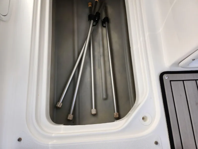 Slide: The Image of Storage compartment with metal rods in 2019 Hurricane SunDeck Sport 202 IO boat. - 16