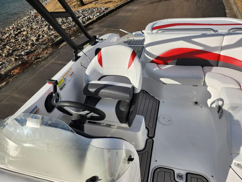 Slide: The Image of 2019 Hurricane SunDeck Sport 202 IO boat interior with seating and steering wheel. - 21
