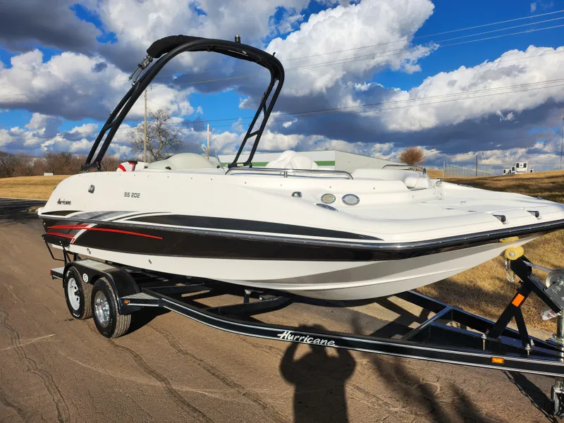 Slide: The Image of 2019 Hurricane SunDeck Sport 202 IO boat on trailer under cloudy sky. - 5