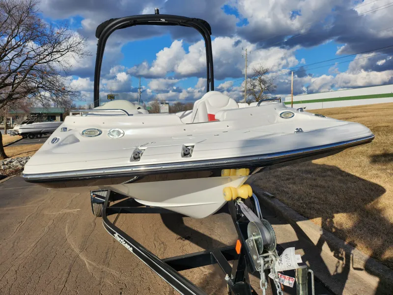 Slide: The Image of 2019 Hurricane SunDeck Sport 202 IO boat on trailer under cloudy sky. - 6