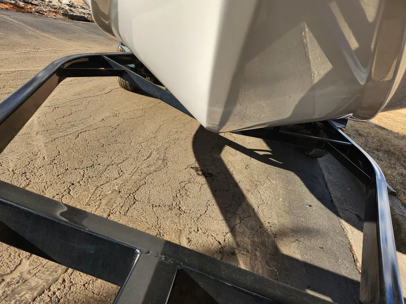 Slide: The Image of 2019 Hurricane SunDeck Sport 202 IO boat on a trailer, close-up view. - 7