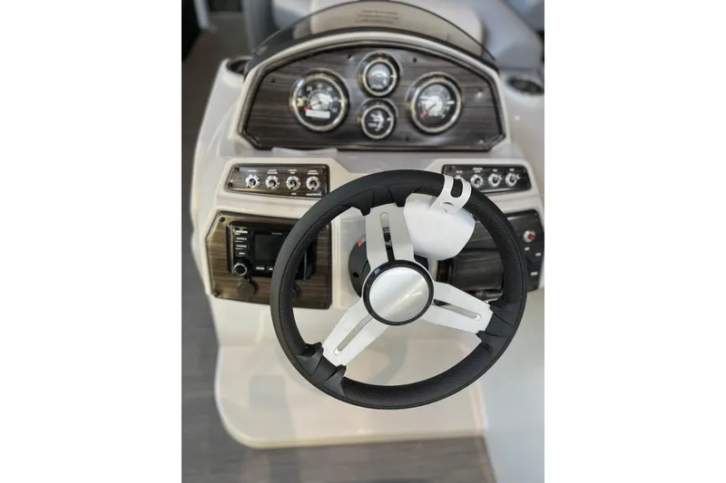 Slide: The Image of Steering console of 2023 Lowe SS 210 WT boat with gauges and controls. - 5