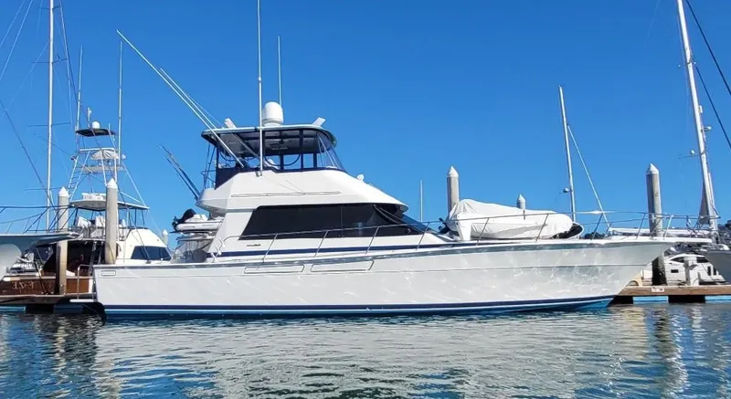 The Image of 1997 Mediterranean 54 Convertible yacht docked in marina under clear blue sky. - 1