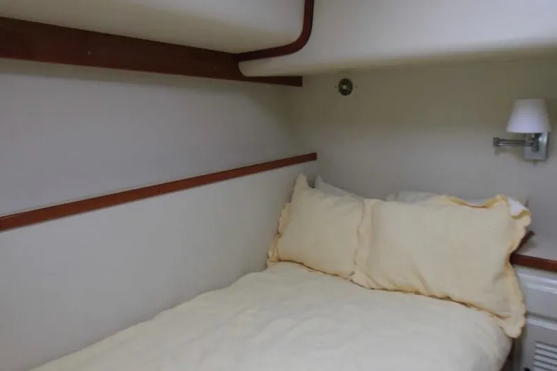 Slide: The Image of Cozy cabin bedroom in 1997 Mediterranean 54 Convertible yacht with soft lighting. - 10