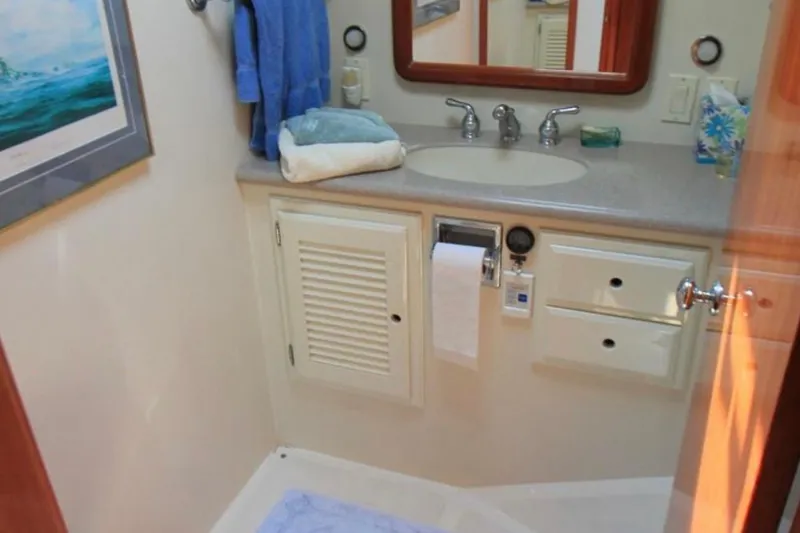 Slide: The Image of Bathroom interior of 1997 Mediterranean 54 Convertible yacht with sink, towels, and mirror. - 11