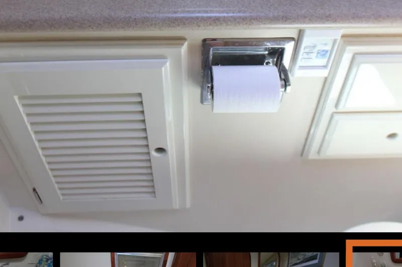Slide: The Image of 1997 Mediterranean 54 Convertible yacht bathroom with toilet paper holder and vent. - 12