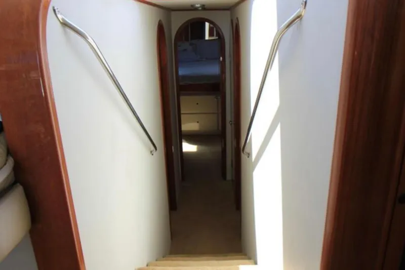 Slide: The Image of Interior hallway of a 1997 Mediterranean 54 Convertible yacht with wooden accents. - 5