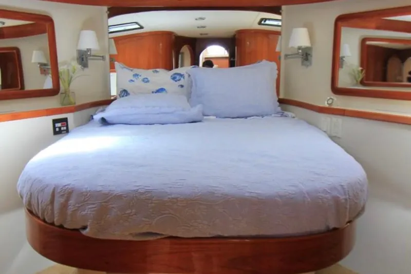 Slide: The Image of Luxurious bedroom interior of 1997 Mediterranean 54 Convertible yacht with elegant bedding. - 7
