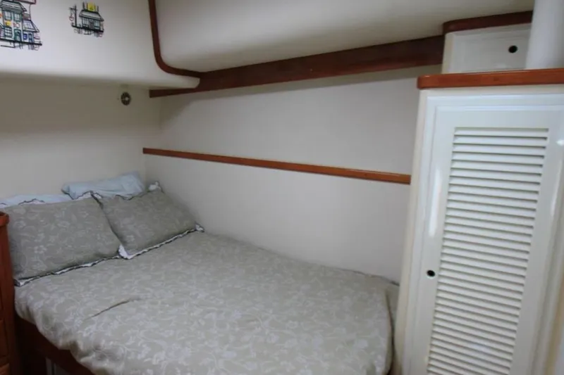 Slide: The Image of Cozy bedroom in 1997 Mediterranean 54 Convertible yacht with double bed and wooden accents. - 8