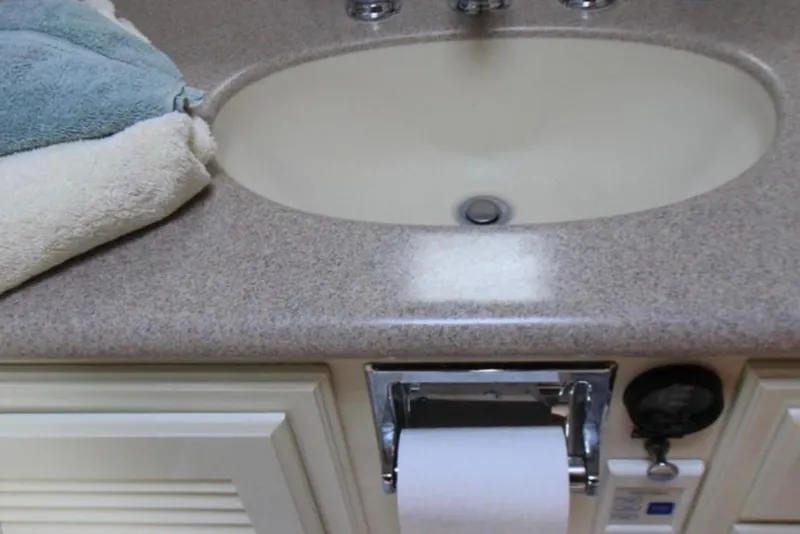 Slide: The Image of Bathroom sink with towels and toilet paper in a 1997 Mediterranean 54 Convertible. - 9