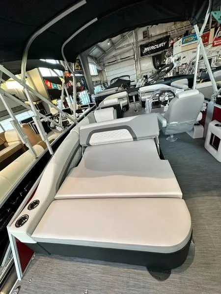 Slide: The Image of 2023 Lowe SS23CL boat interior with cushioned seating and canopy in showroom. - 6