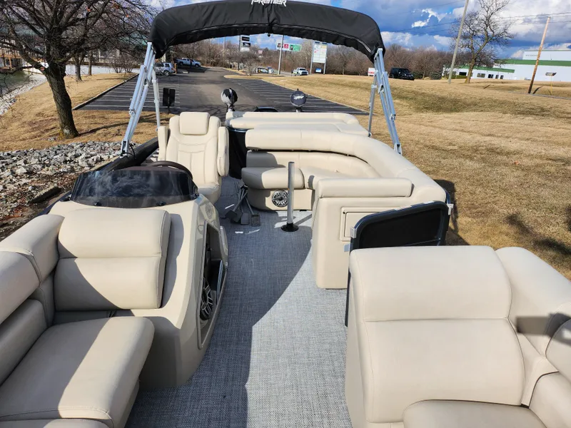 Slide: The Image of 2019 Premier 250 Grand Majestic RE pontoon boat with beige seating and canopy. - 12