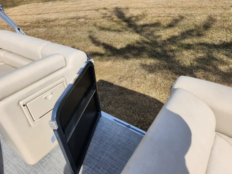 Slide: The Image of 2019 Premier 250 Grand Majestic RE boat interior with open door and beige seating. - 13