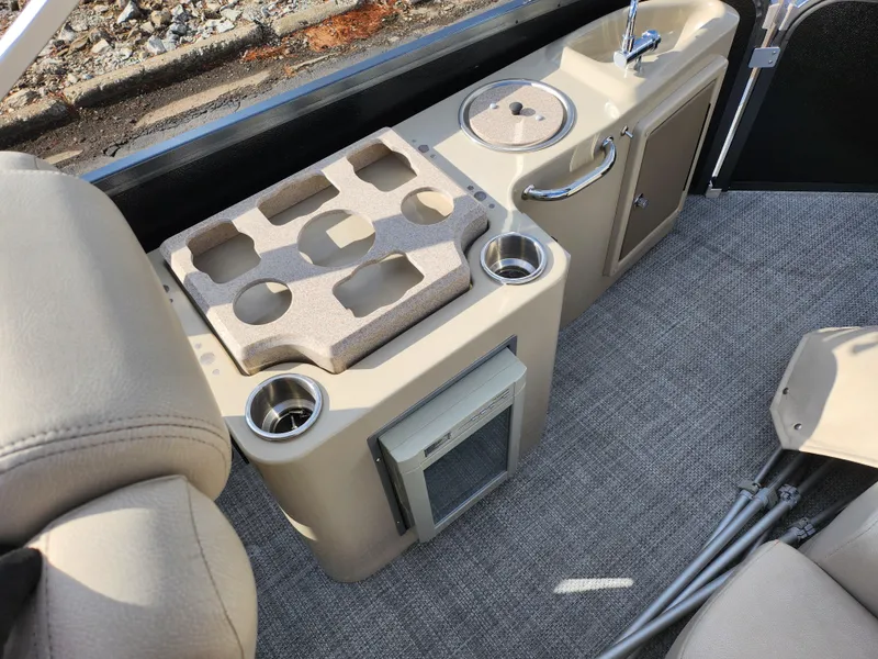 Slide: The Image of 2019 Premier 250 Grand Majestic RE boat interior with cup holders and storage. - 18
