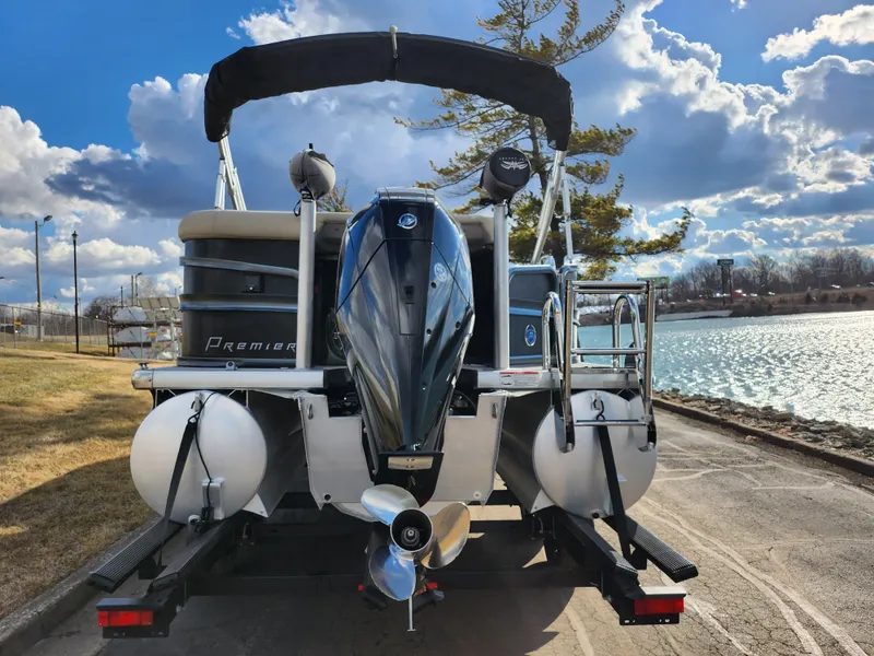 Slide: The Image of 2019 Premier 250 Grand Majestic RE pontoon boat by a scenic lake. - 2