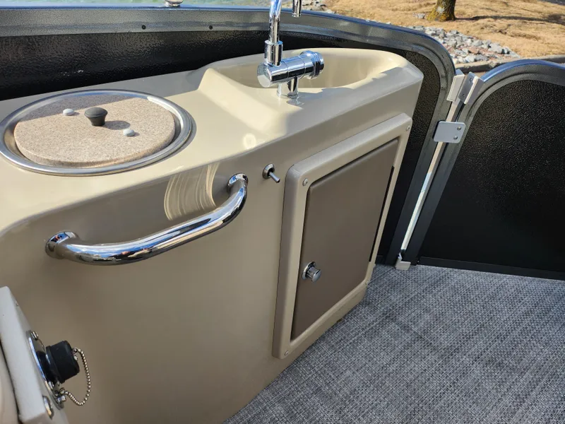 Slide: The Image of 2019 Premier 250 Grand Majestic RE boat interior with sink and storage compartment. - 20