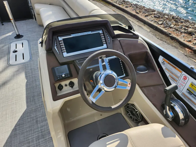 Slide: The Image of 2019 Premier 250 Grand Majestic RE boat dashboard with steering wheel and control panel. - 25