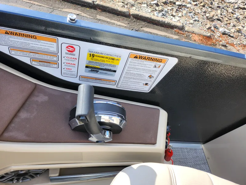 Slide: The Image of 2019 Premier 250 Grand Majestic RE boat interior with warning labels and control handle. - 26