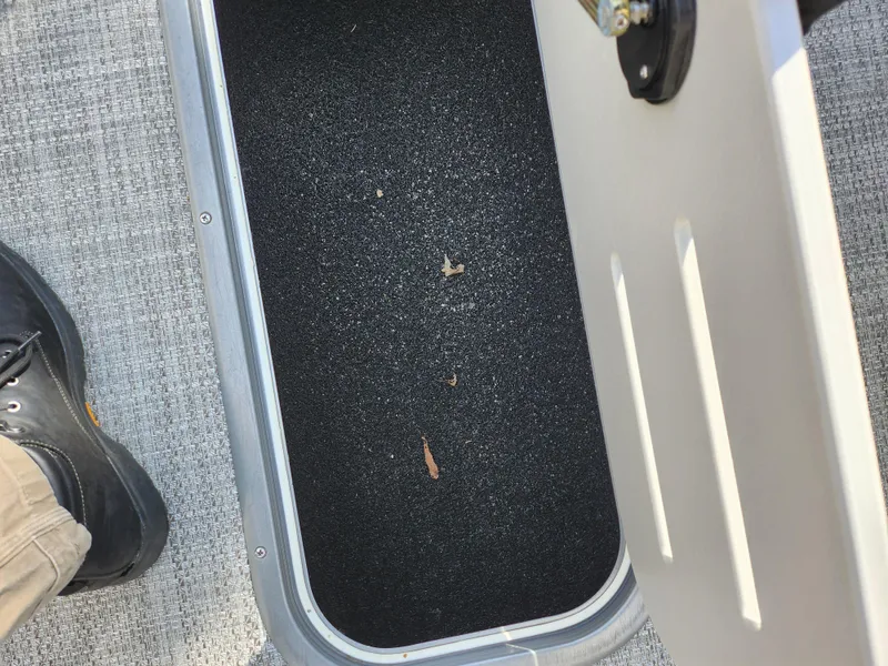 Slide: The Image of Open storage compartment on a 2019 Premier 250 Grand Majestic RE boat. - 28