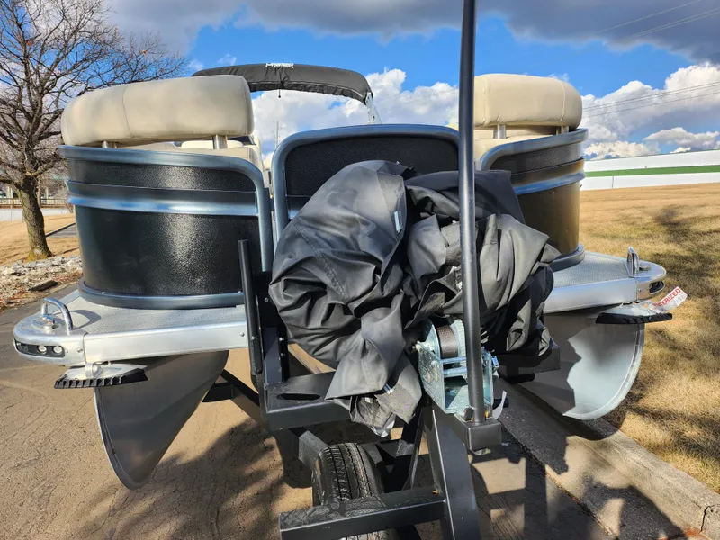 Slide: The Image of 2019 Premier 250 Grand Majestic RE pontoon boat on trailer, outdoor setting. - 6