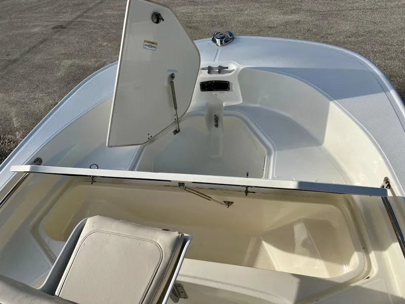 Slide: The Image of 2023 Boston Whaler 190 Montauk boat interior with open storage compartments. - 16