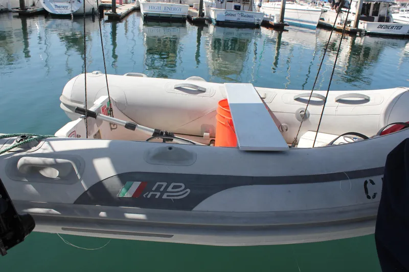 Slide: The Image of Inflatable boat docked near Beneteau Oceanis 461, 1997 model, in a marina setting. - 13