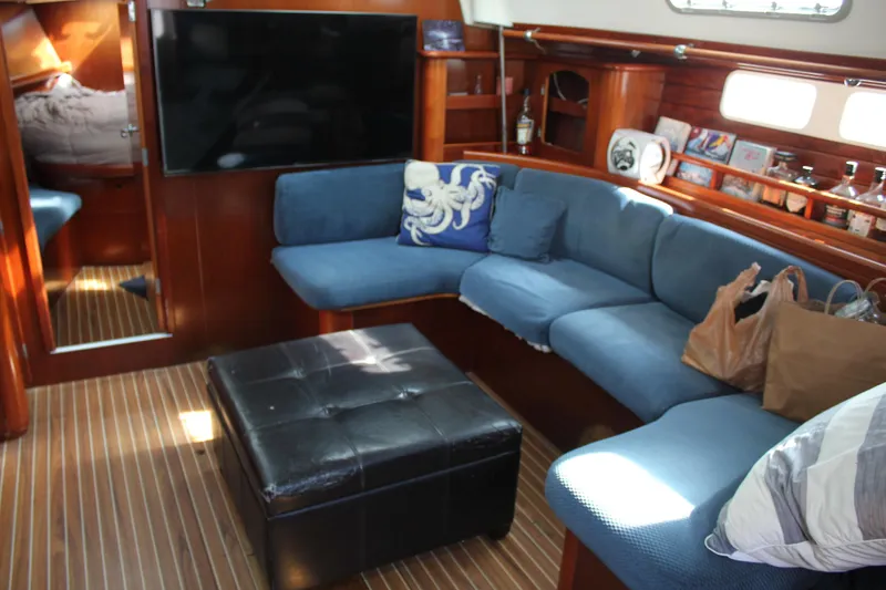Slide: The Image of Interior of 1997 Beneteau Oceanis 461 yacht with blue seating and wooden accents. - 19