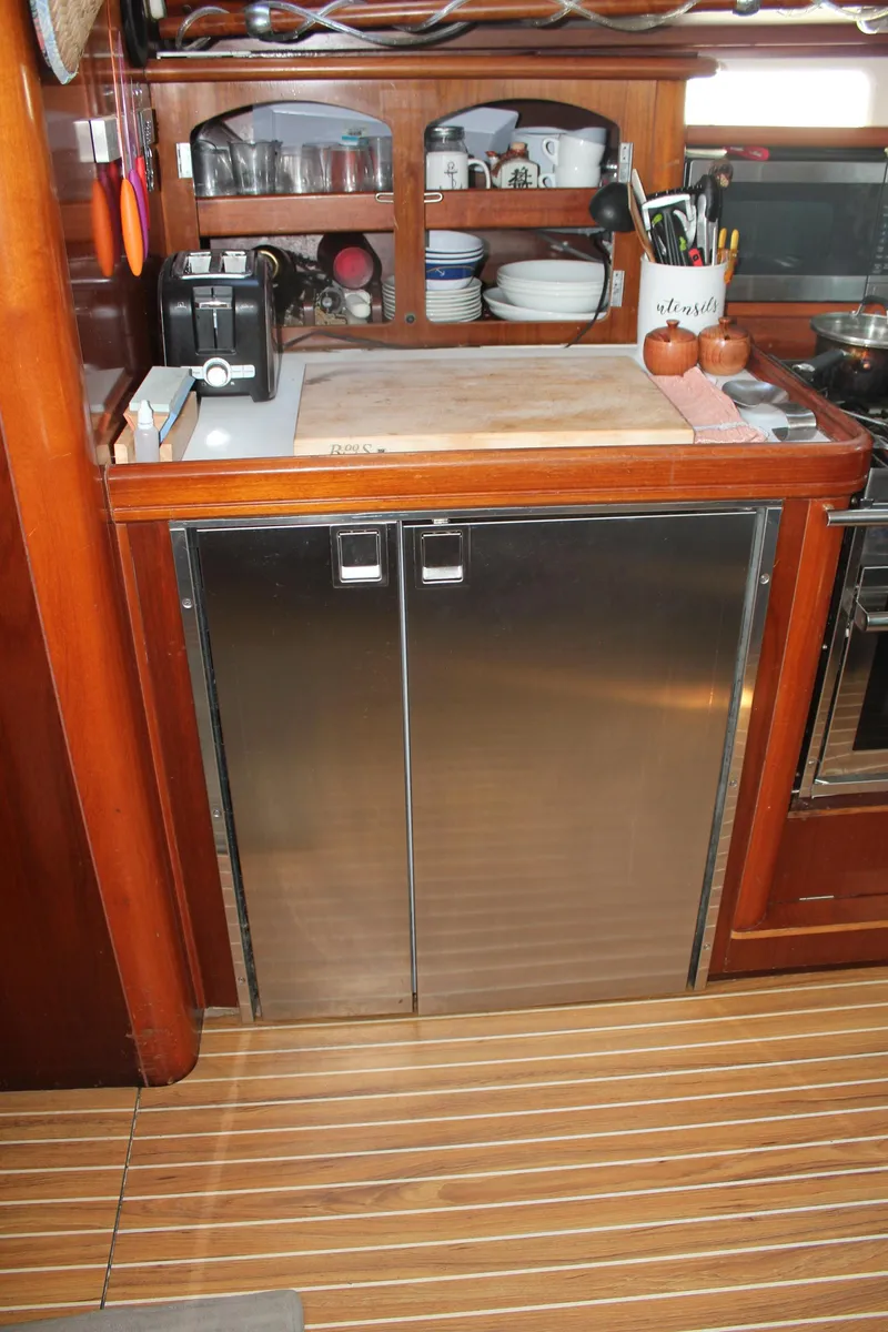 Slide: The Image of Galley kitchen in 1997 Beneteau Oceanis 461 yacht with stainless steel cabinets. - 20