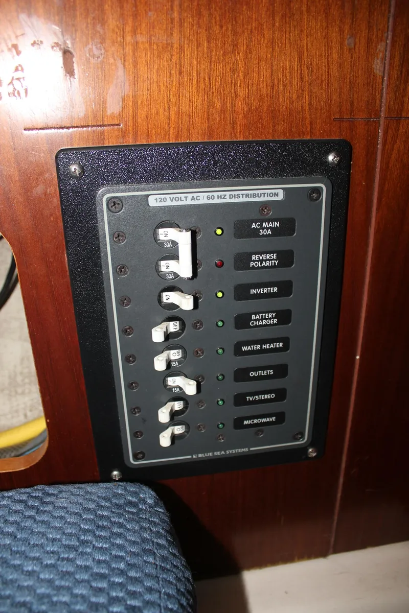 Slide: The Image of Electrical panel on a 1997 Beneteau Oceanis 461 sailboat, featuring various switches and indicators. - 23